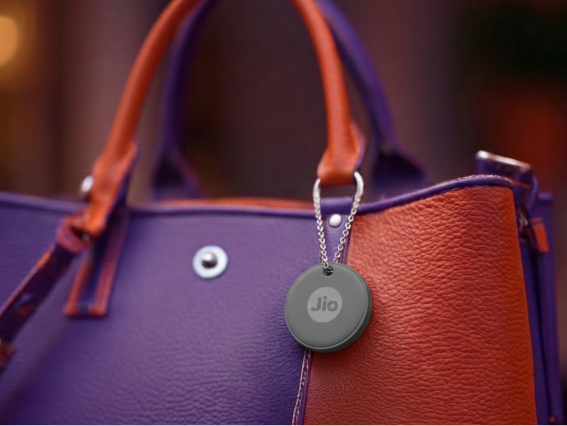 A Grey JioTag clipped to a handbag